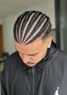 This image shows a bulky man in braids as a suggested long hairstyle for the gym.